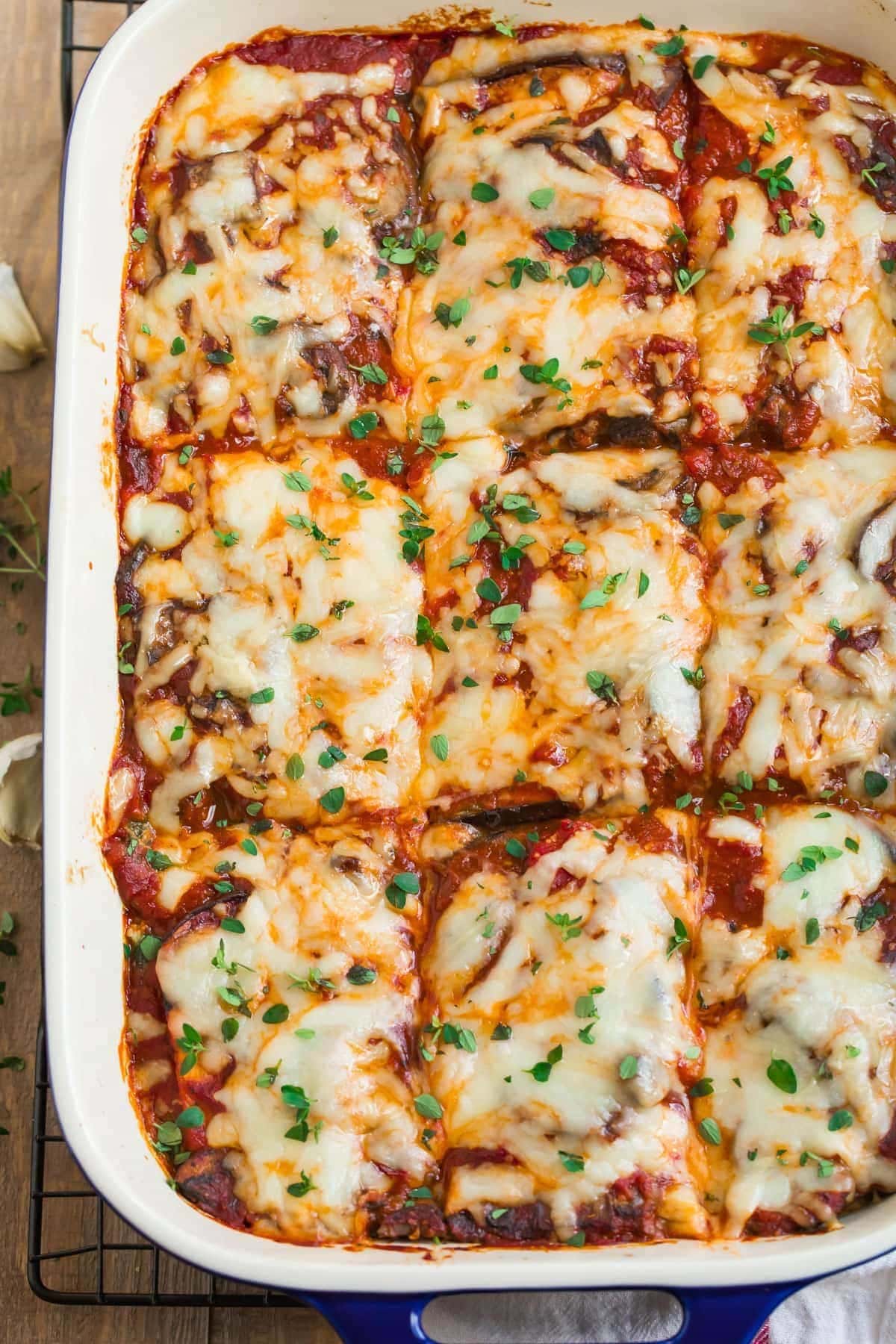 Cheesy eggplant lasagna in a blue casserole dish. 