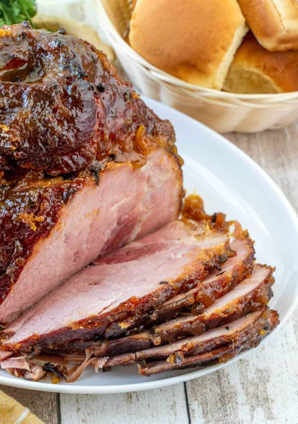 Sliced pineapple glazed ham on a plate. 