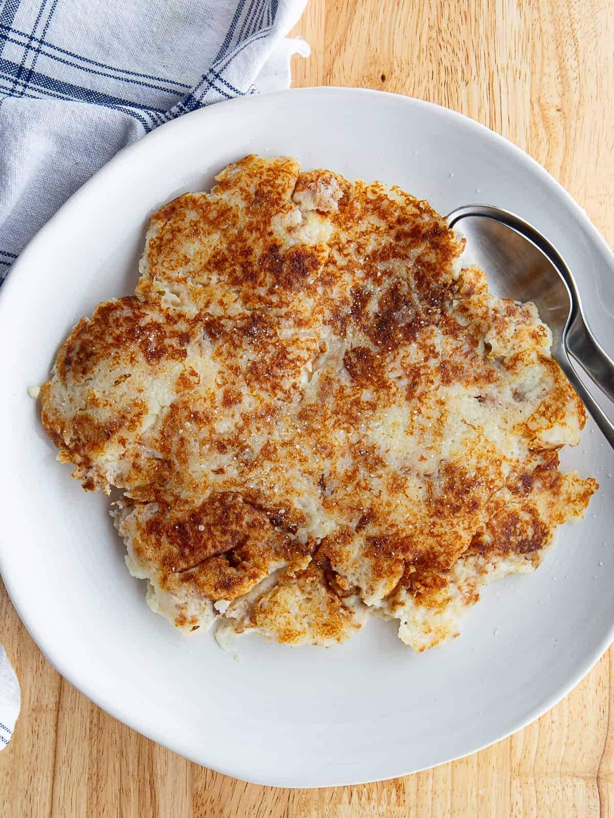 Fried mashed potatoes on a white plate. 