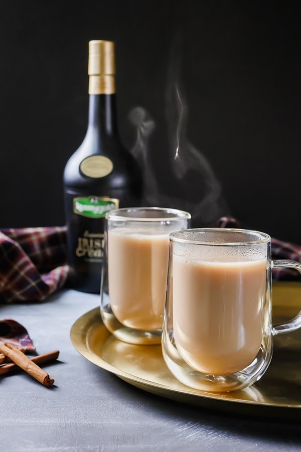 Warm creamy cocktails on a glass mug.