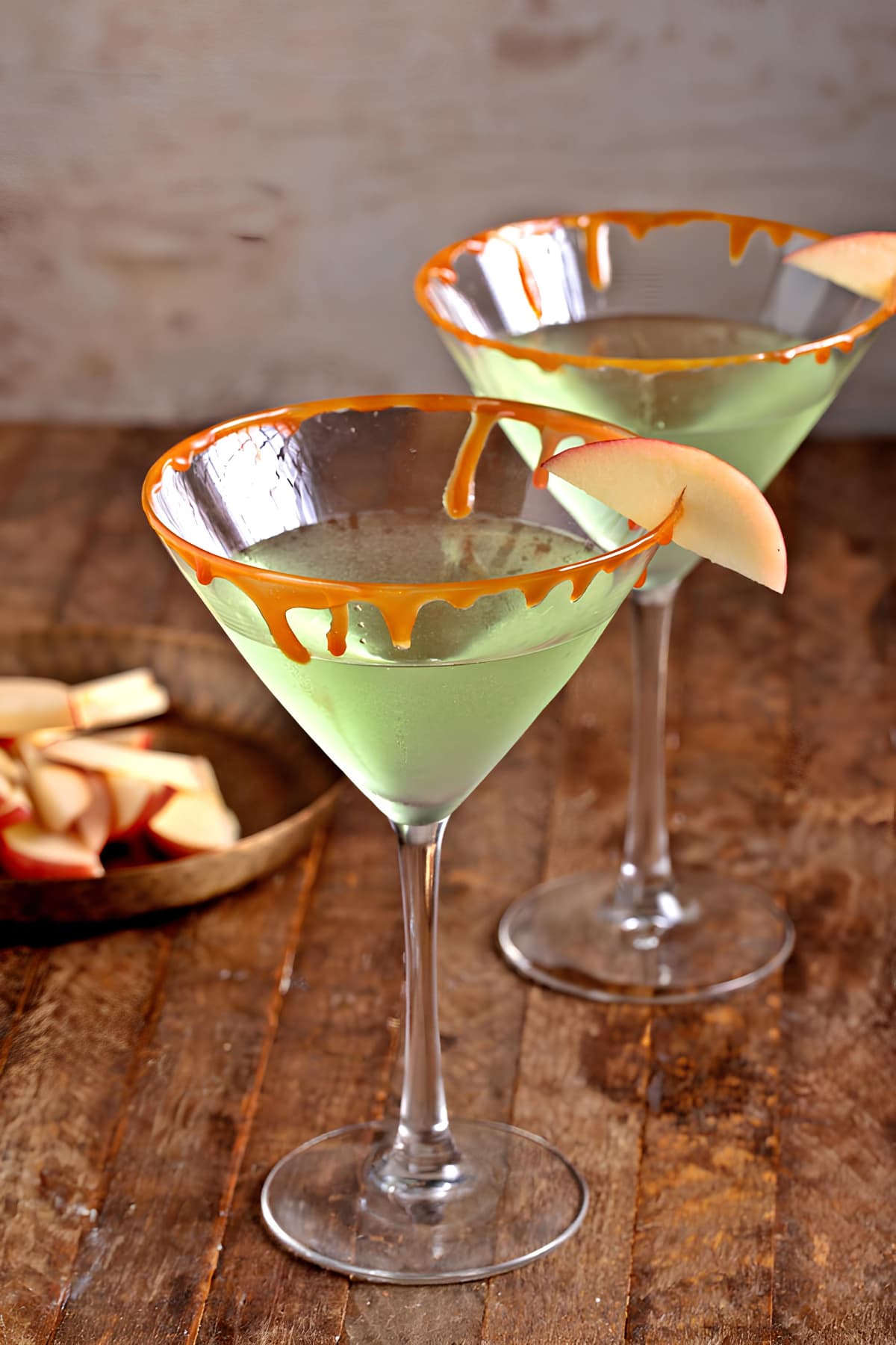 Caramel Apple Martini (Easy Recipe) featuring Two glasses of homemade caramel martini in wine glasses