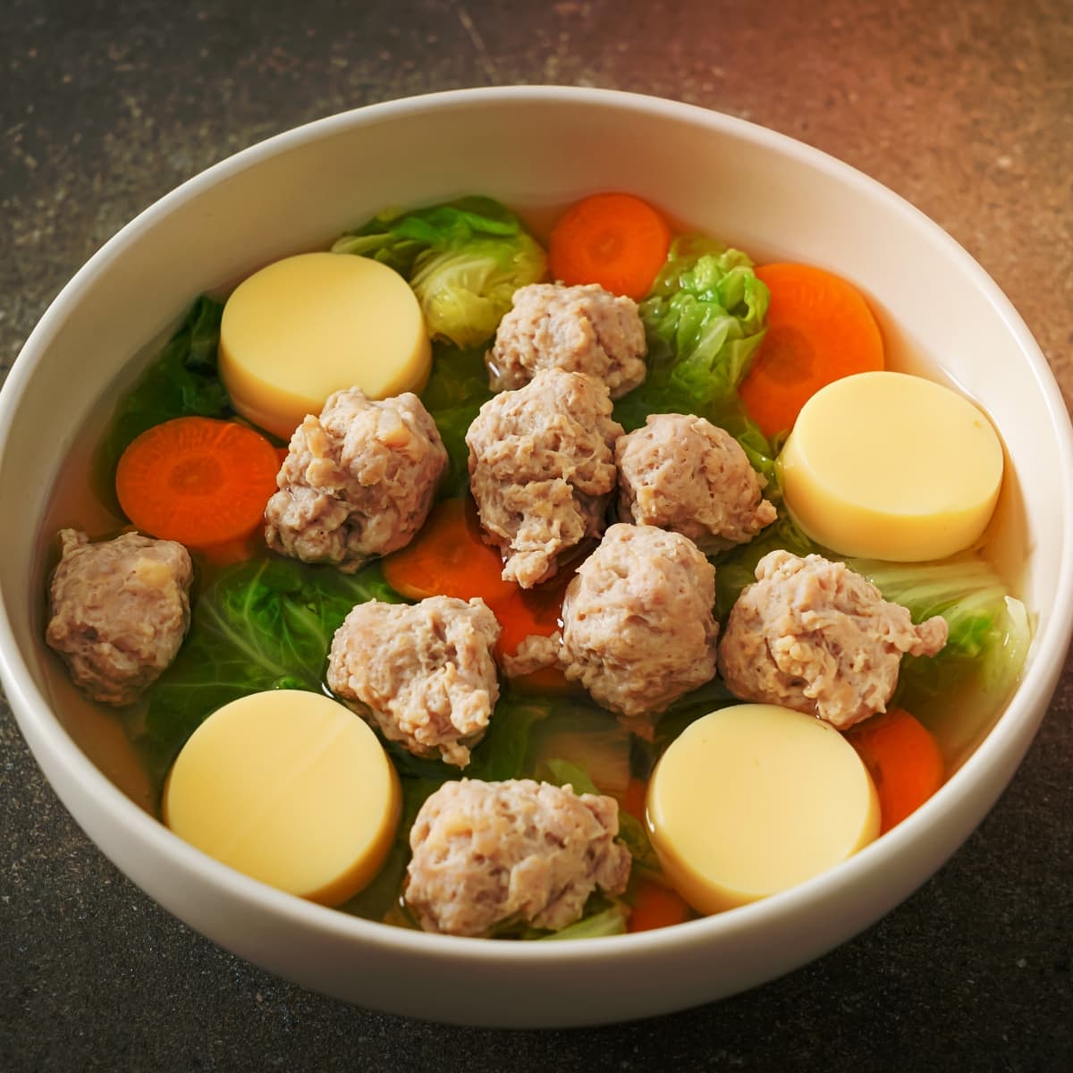 Homemade Clear Soup in a Bowl with Minced Pork, Carrots and Cabbage