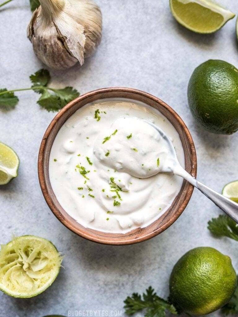 Bowl of homemade lime crema with salt and garlic