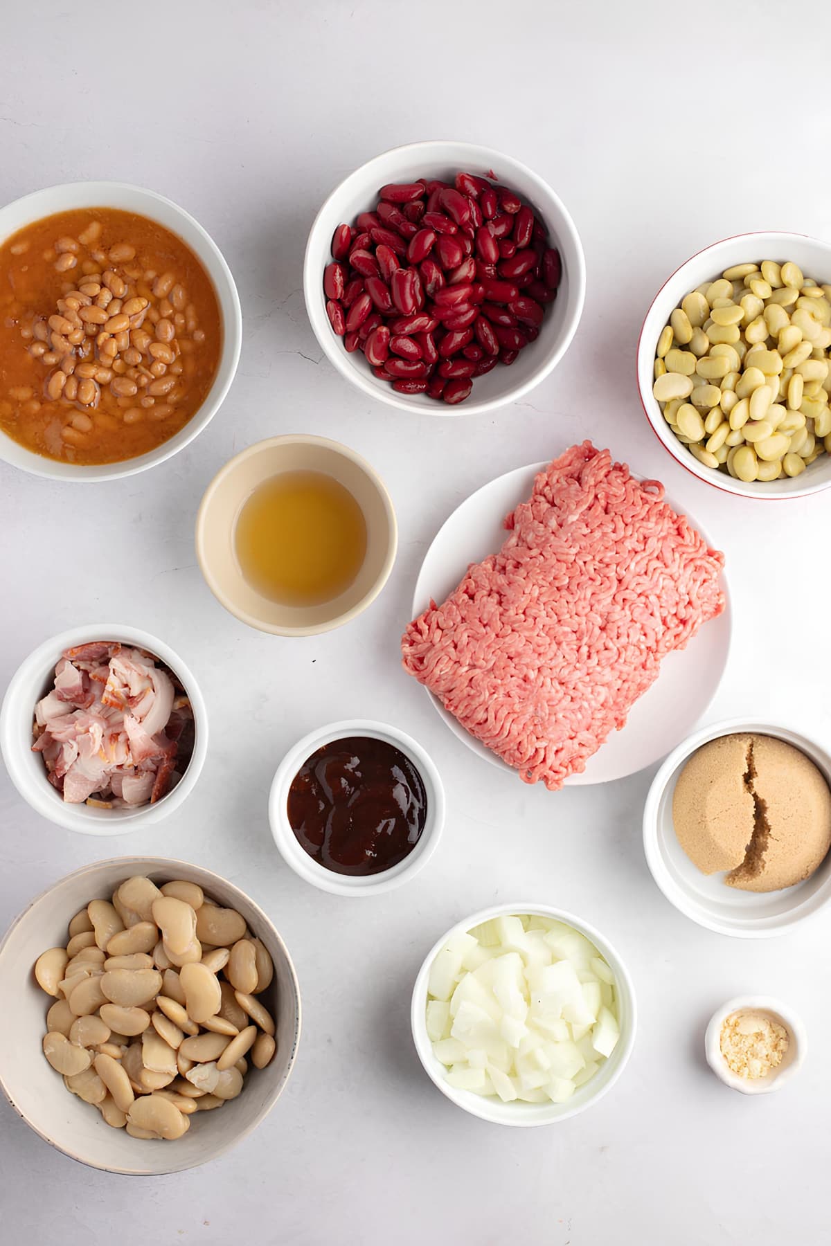 Bowl of Ingredients for Calico Beans: Ground Beef, Bacon, Pork and Beans, Sugar, Chopped Onion and BBQ Sauce