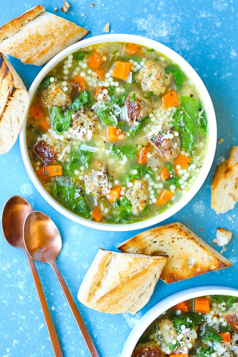 Top view of a soup in a bowl wit meatballs loaded with veggies and herbs. 