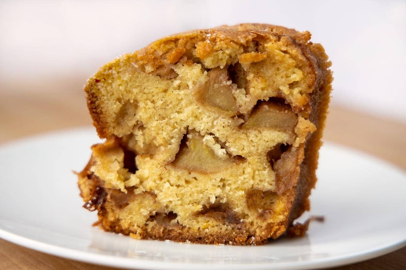 A slice of Jewish apple cake on a plate.