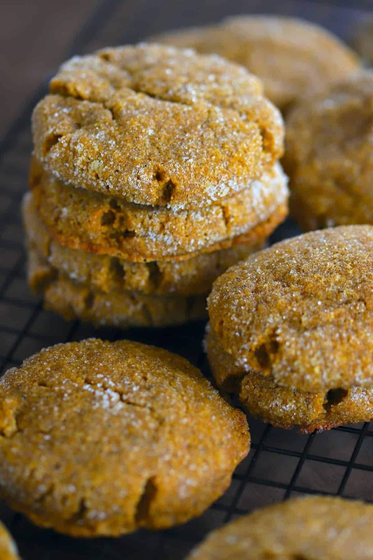 Bunch of pumpkin cookies on a cooling rack.