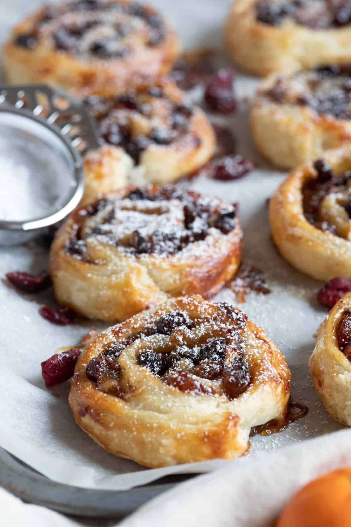 A tray of fruit-filled pastries sprinkled with sugar.