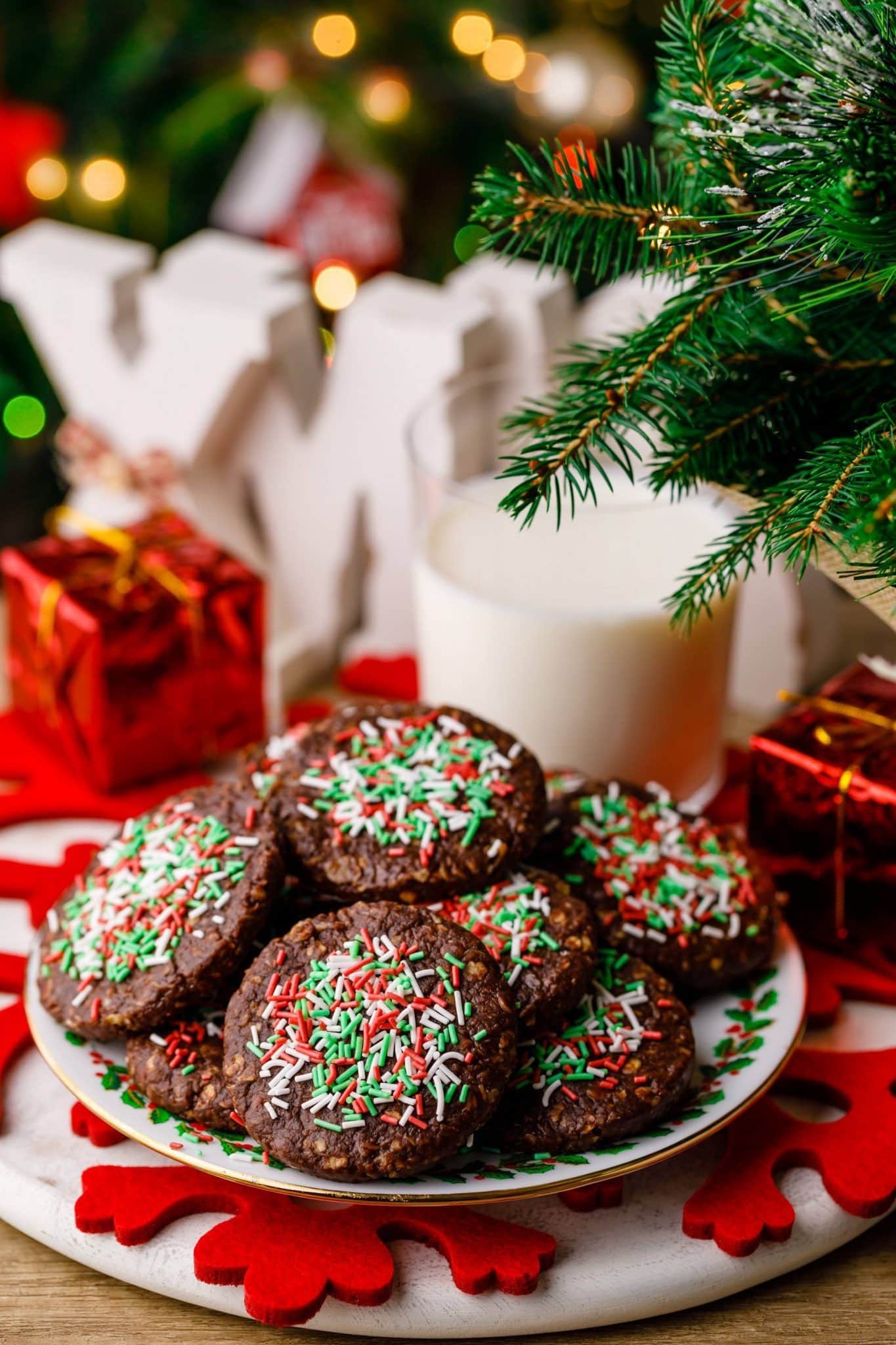 Bunch of chocolate cookies topped with sprinkles. 