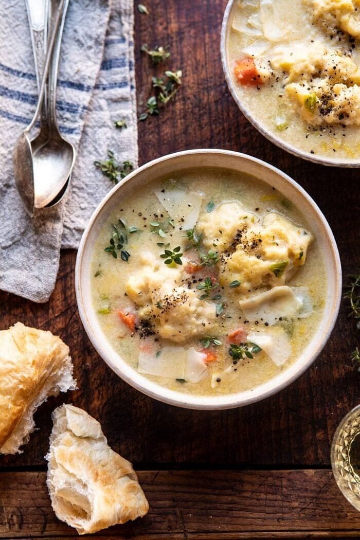 Top view of two bowls of potato dumplings and turkey meat with broth. 