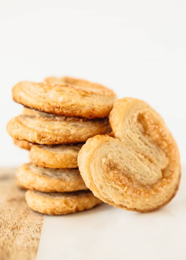 A stack of crunchy pastries stacked on a white surface. 