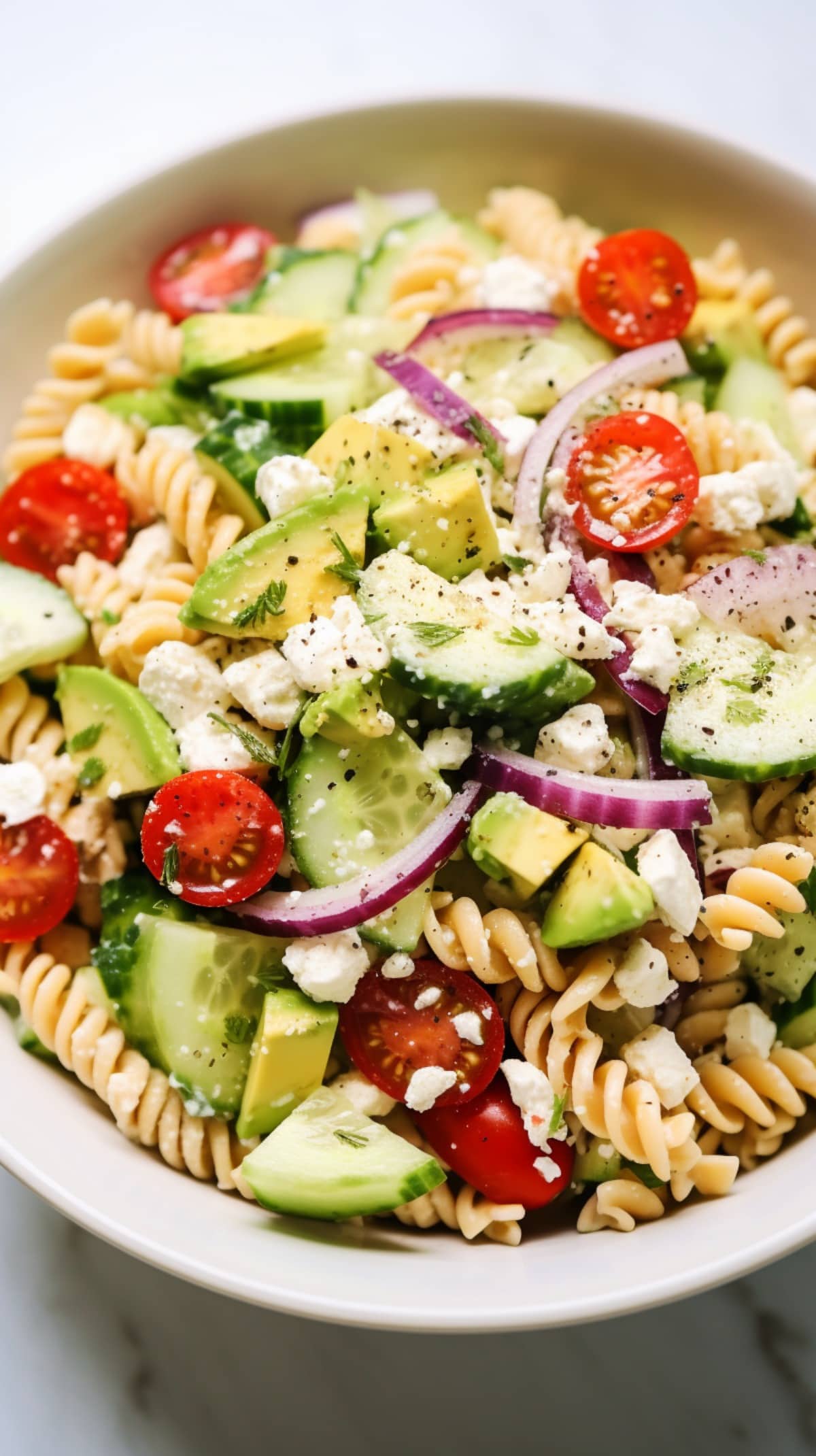 Pasta Salad with tomatoes, cucumber, red onion, feta, and avocado