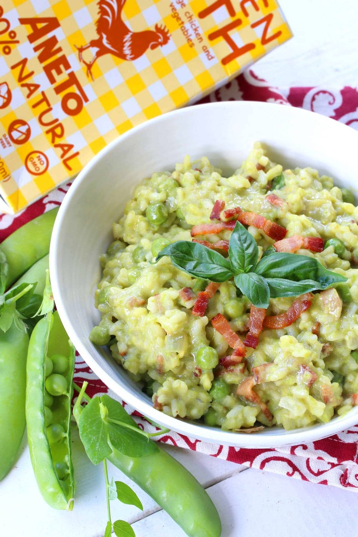 Sweet pea risotto with basil & pancetta in a bowl. 