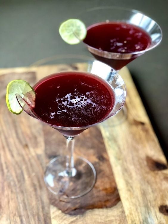 Two servings of red frozen mocktails in cocktail glasses. 