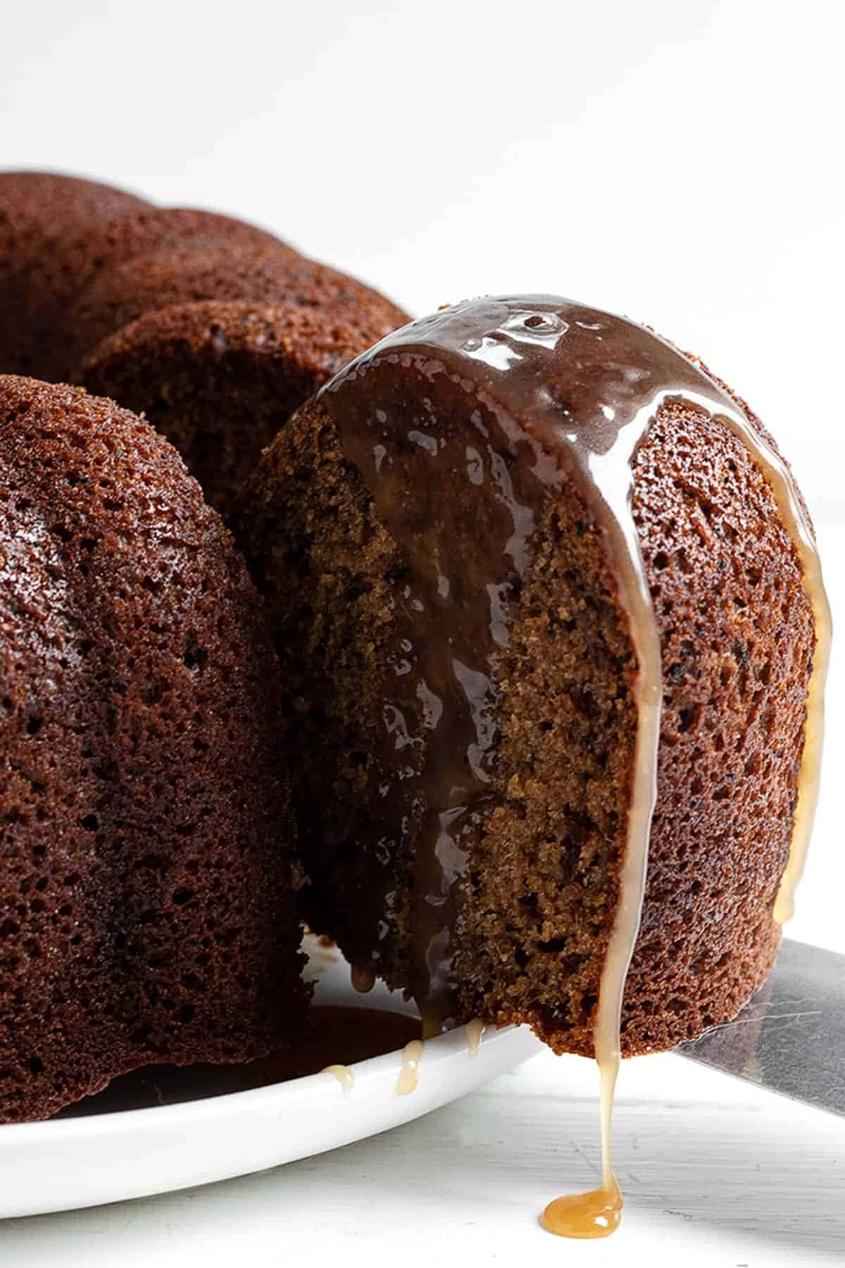 Cut of portion of a Bundt cake with dripping sugar glaze. 