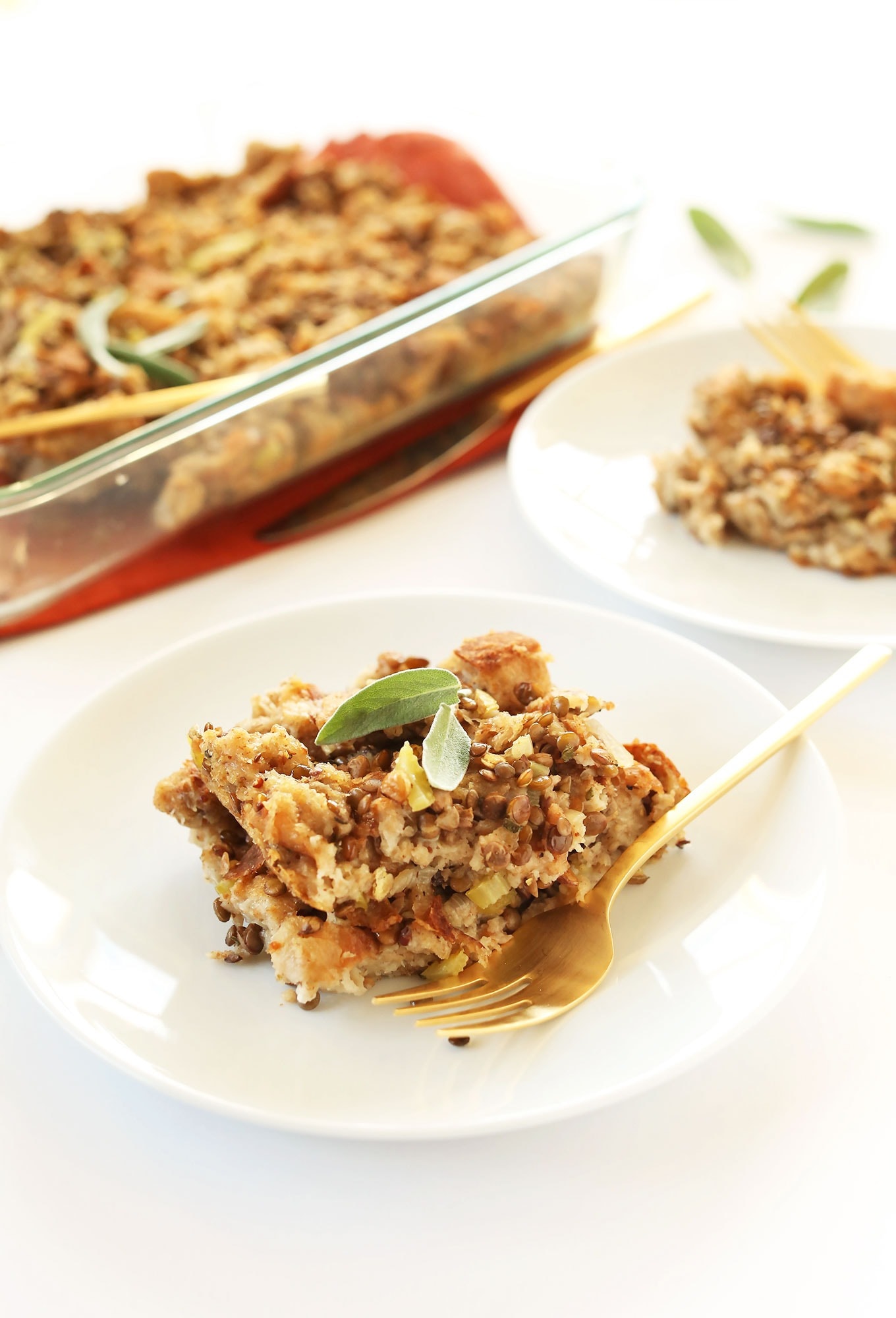 A serving of stuffing with flax seeds on a plate with golden spoon.