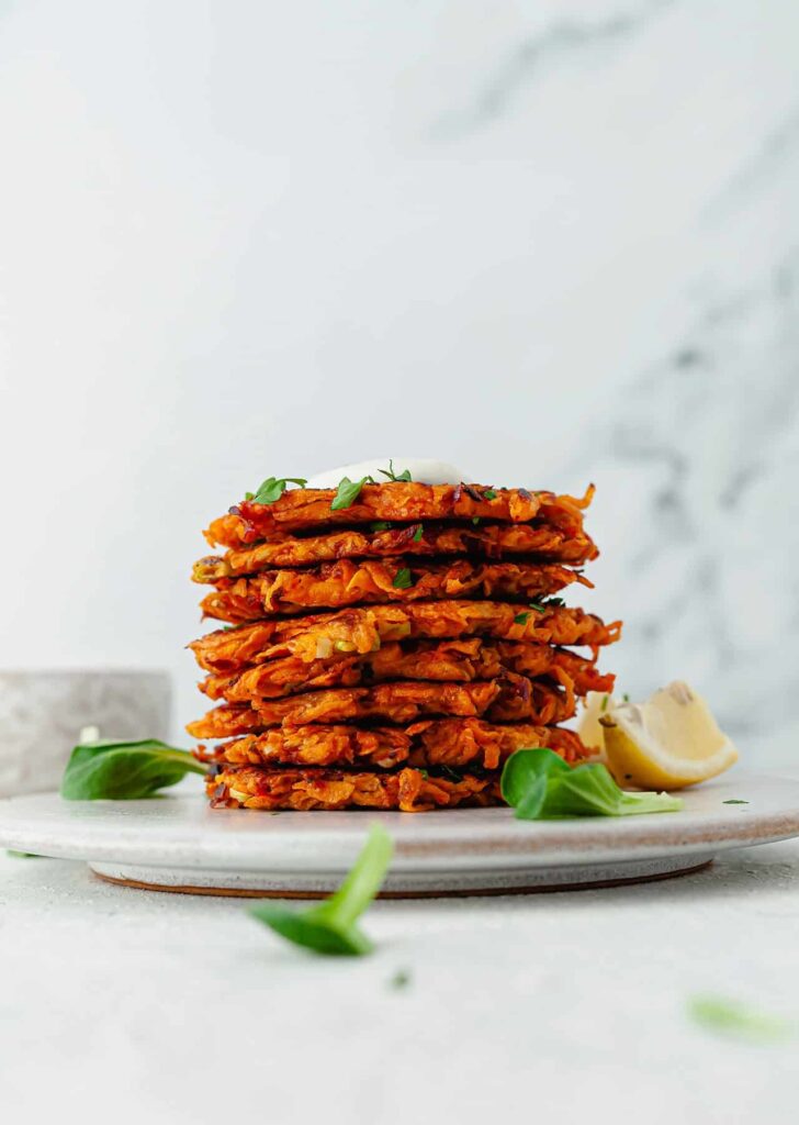 A stack of sweet potato fritters on a plate. 
