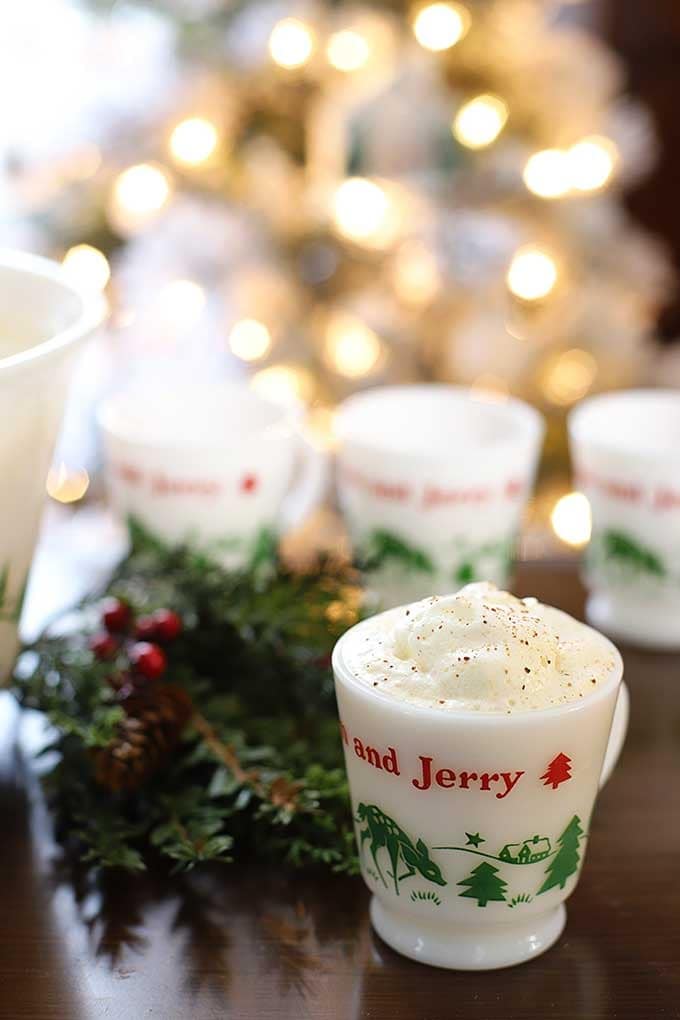 A foamy drink on a Tom and Jerry designed holiday mug. 