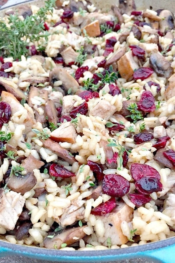 Risotto with turkey meat, mushroom and cranberry in pan. 
