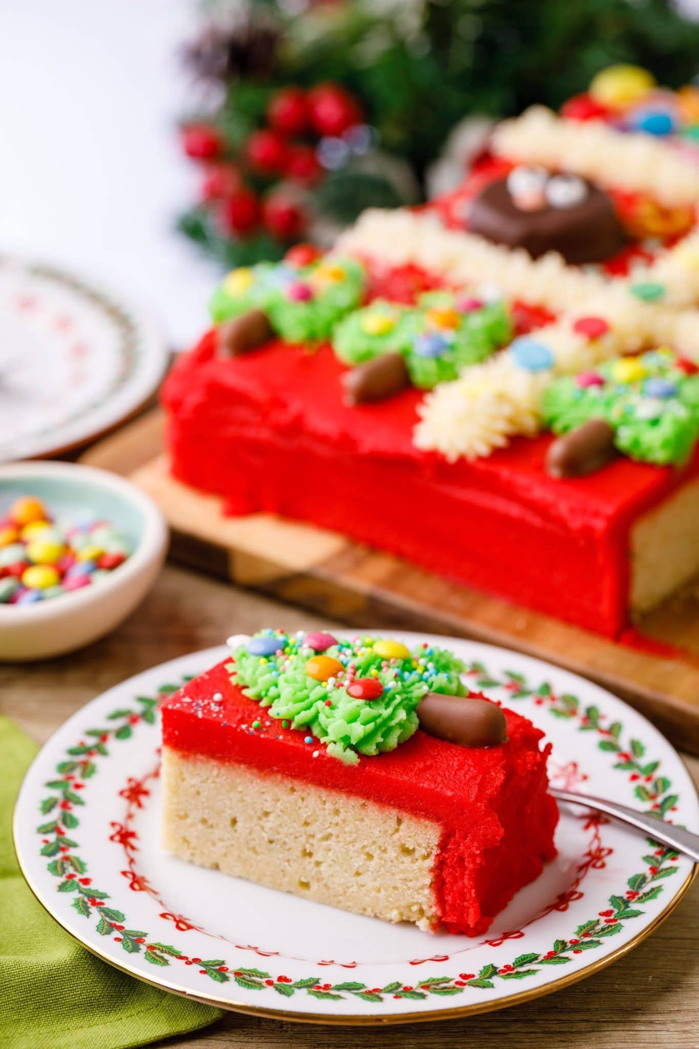 Red frosting covered cake topped with frosting.