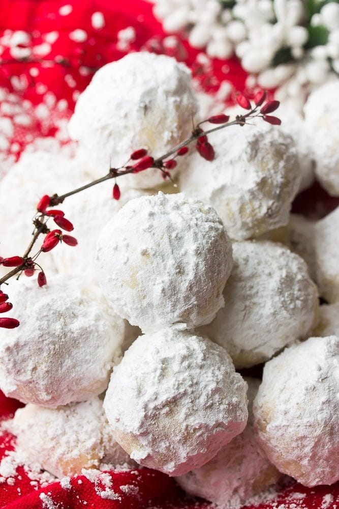 Bunch of snowball cookies coated with powered sugar. 