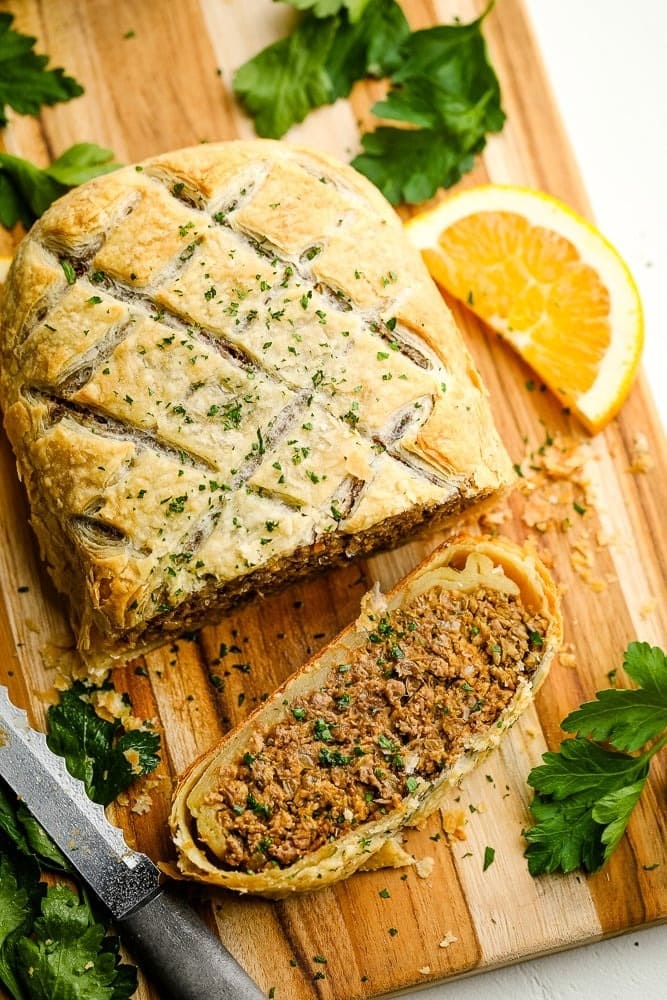 Beef wrapped in puff pasty sliced on a wooden board. 