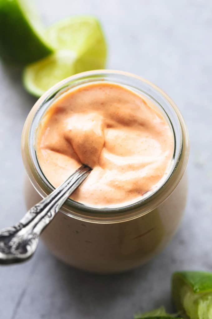 Homemade taco sauce in a jar with spoon