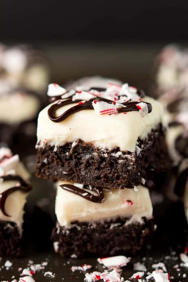 Dark chocolate peppermint brownies topped with cream cheese frosting, ganache, and candy cane.