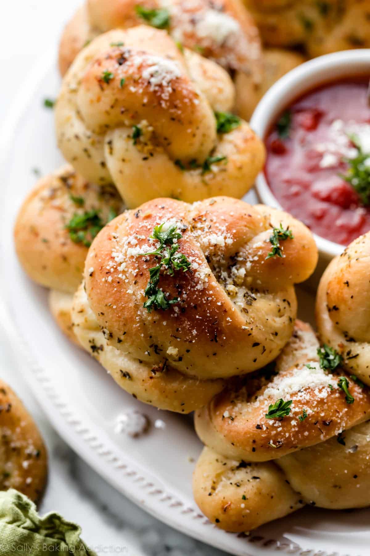 Knotted bread with garlic butter spread on top.