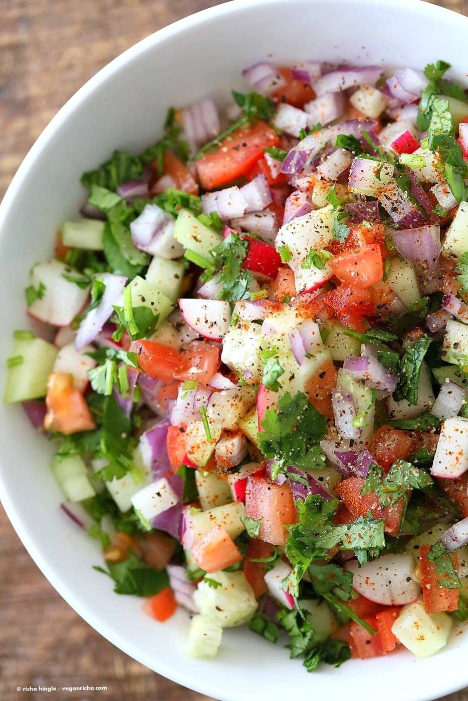Kachumber salad made with chopped cucumber, tomato, and onion.
