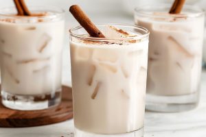 Three Glasses of Mexican Horchata with Ice and Cinnamon Sticks