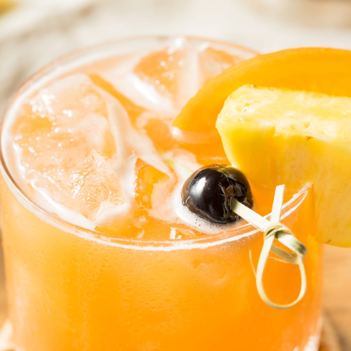 Top view of a rum runner cocktail filled with ice on a glass. 