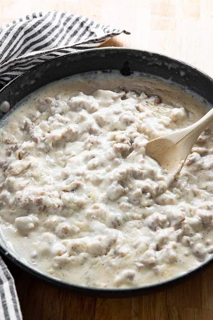 Thick and creamy white sausage gravy mixed on a pan. 