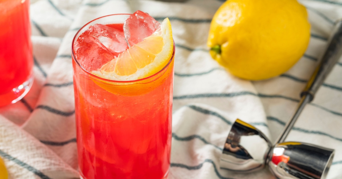 Ice cold sloe gin fizz on a tall glass.