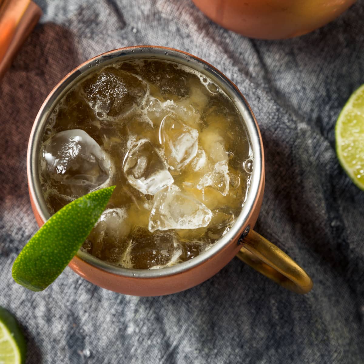 Top view of a serving of ice filled Kentucky mules garnished with mint sprig and lime slice. 