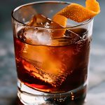 Mezcal Negroni in a Rocks Glass with Ice and an Orange Peel Twist