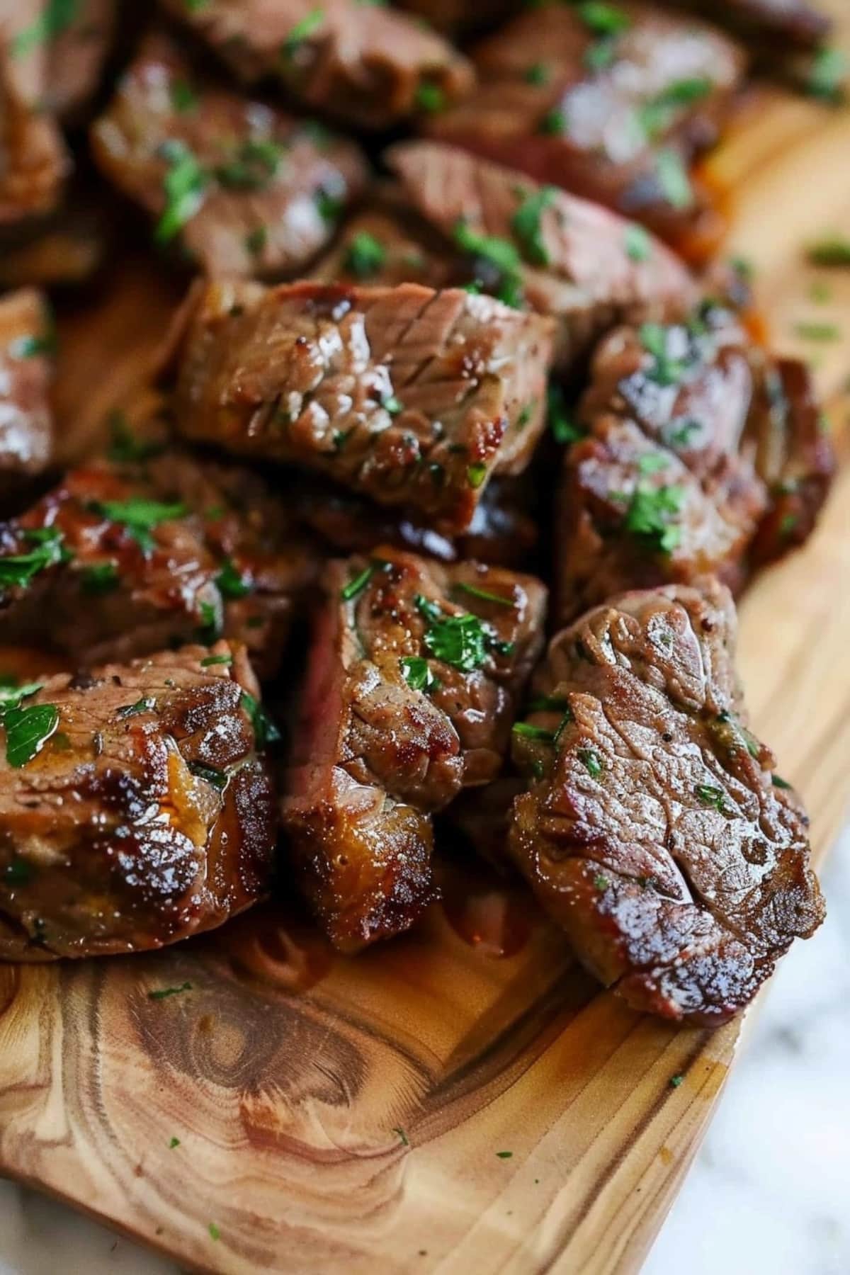 Steak chunks in a wooden board.