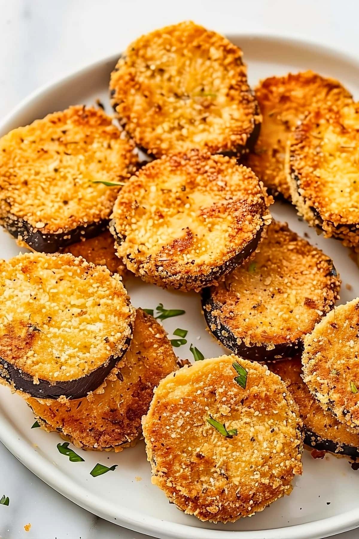 Bunch of breaded eggplant in a plate.