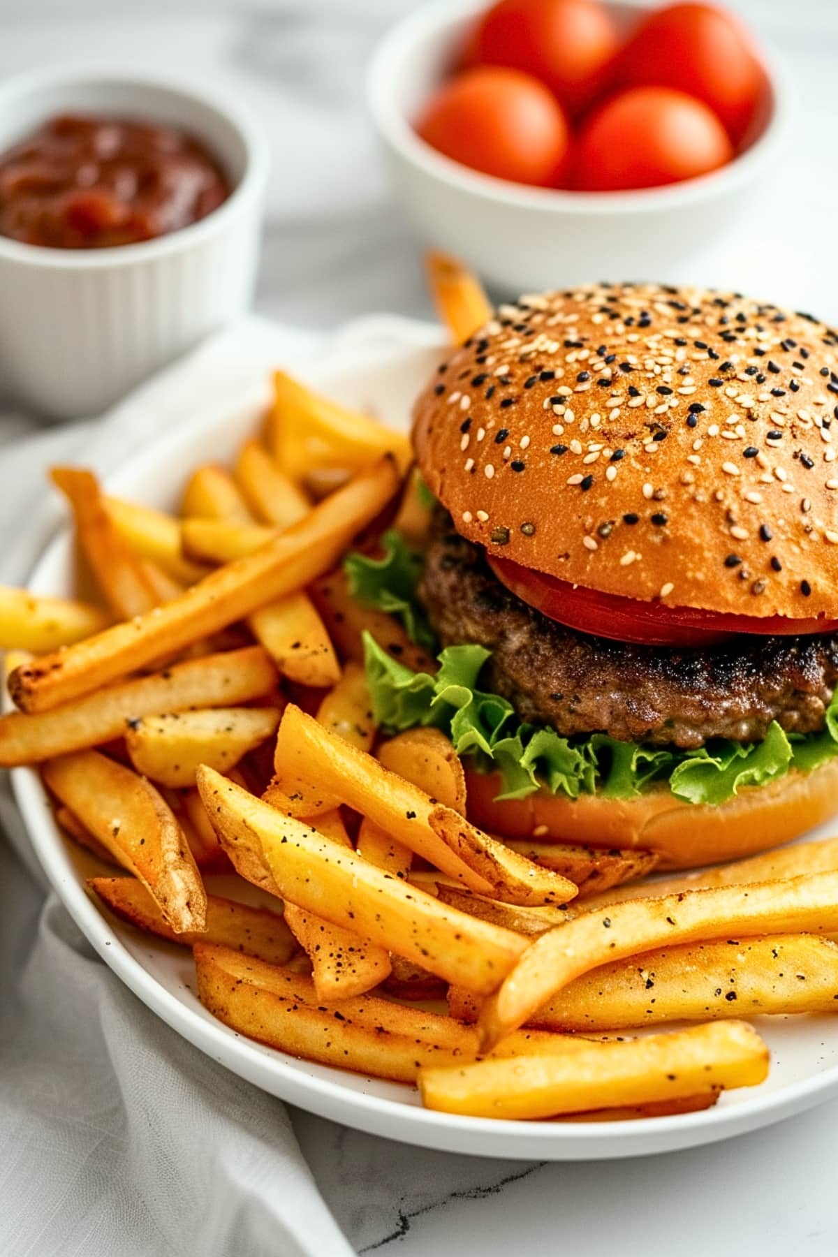 Seasoned french fries served with burger on a plate. 