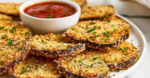 Breaded air fried round sliced eggplant with marinara sauce.