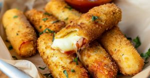 Homemade delicious mozzarella sticks with gooey cheese inside