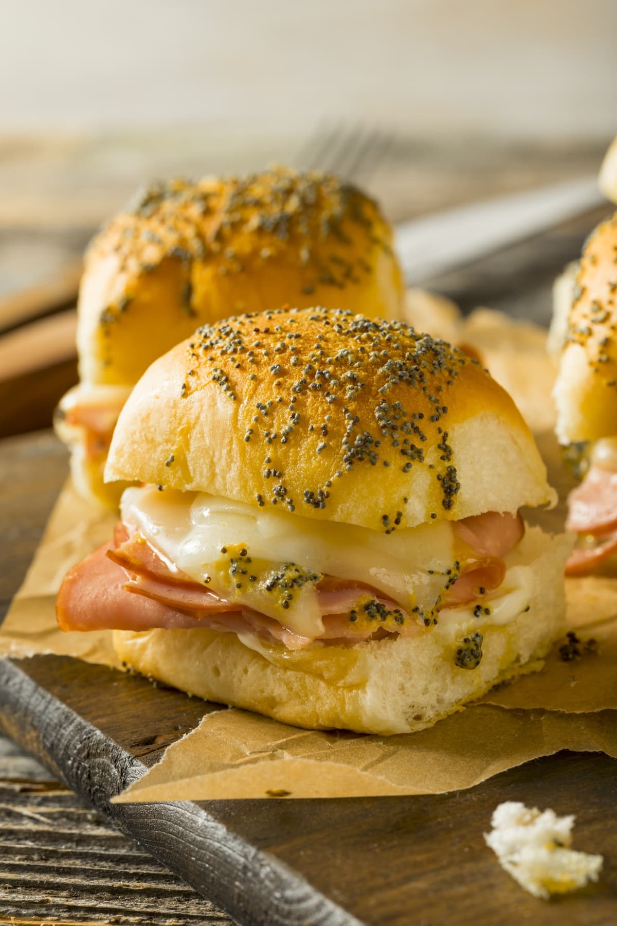 Ham and cheese sliders on parchement paper
