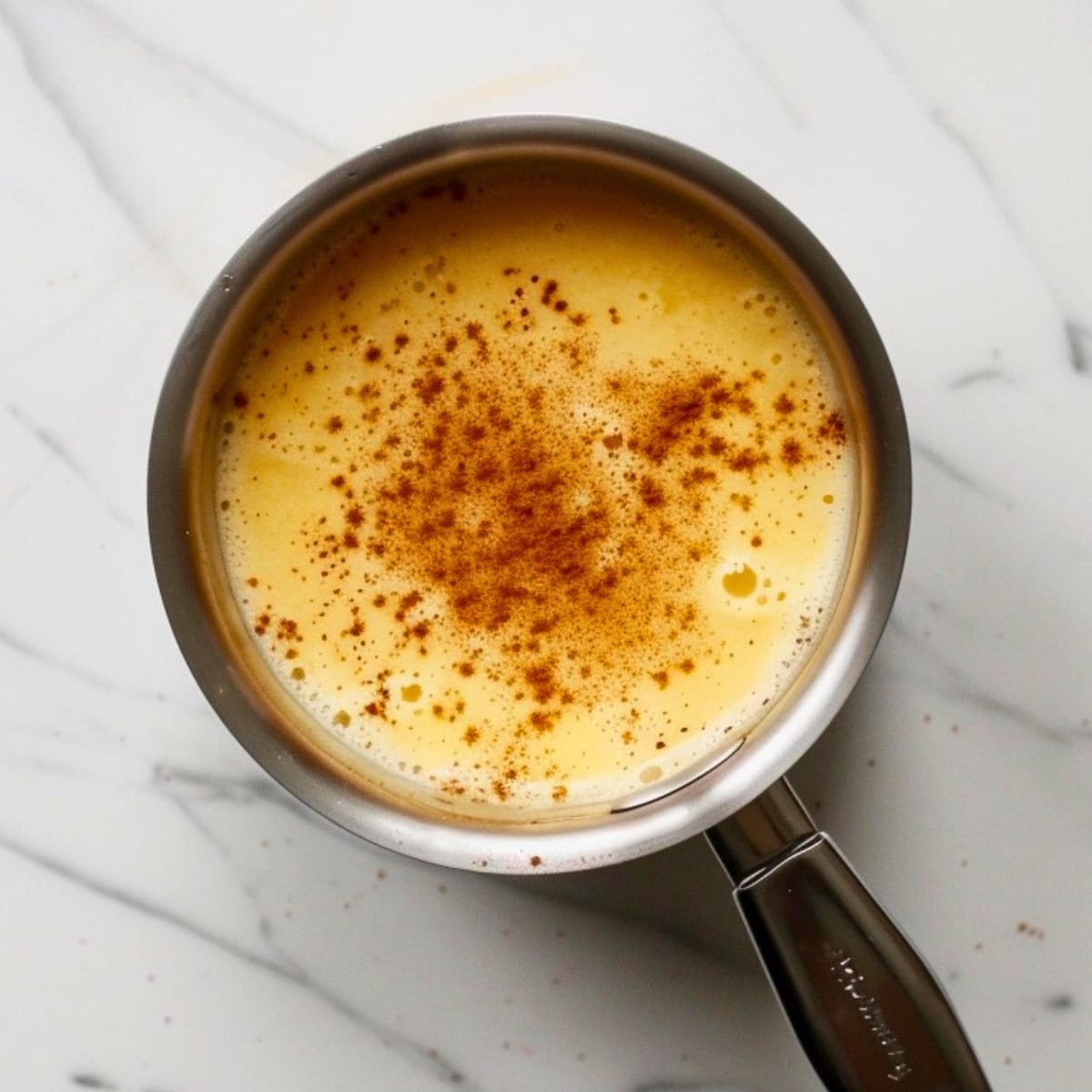 Homemade eggnog in a saucepan.