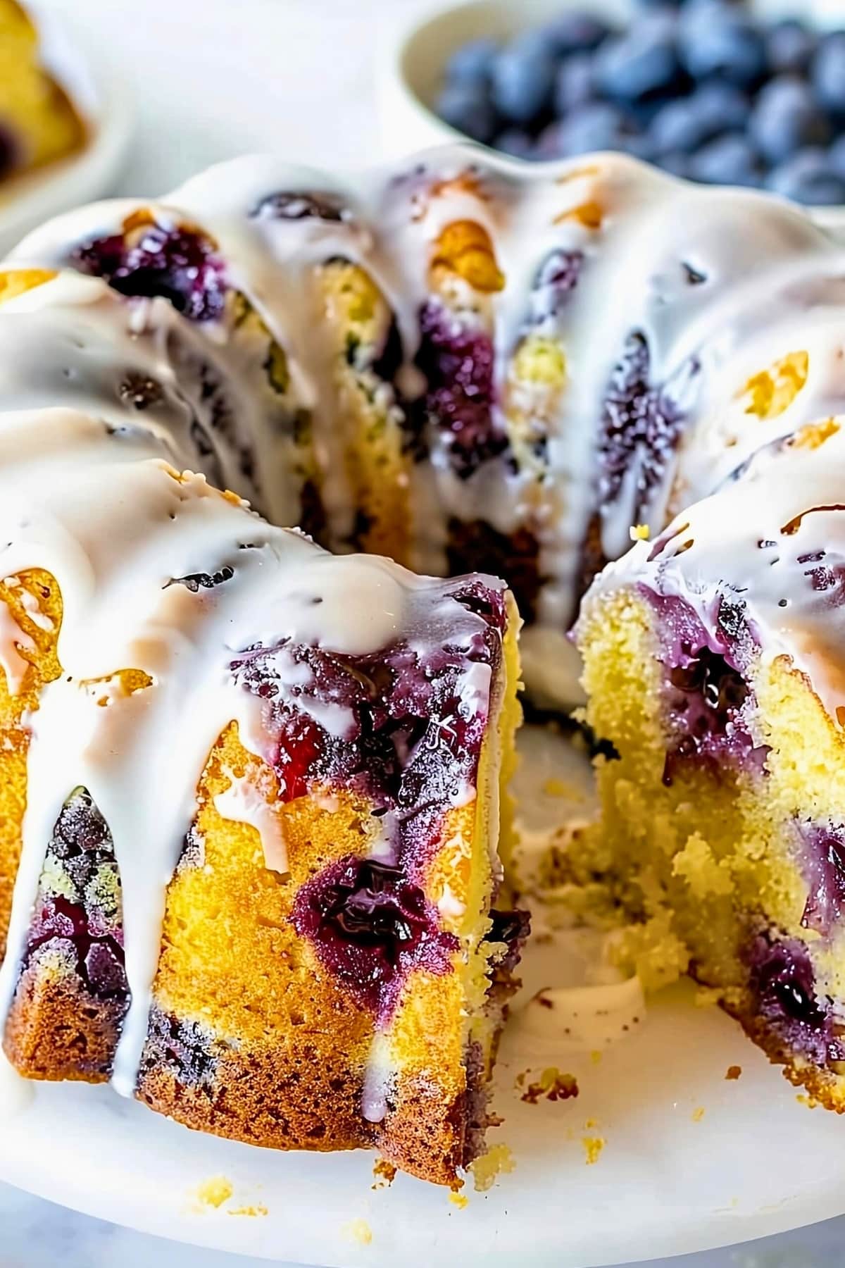 Lemon blueberry pound cake drizzled with lemon glaze on top.