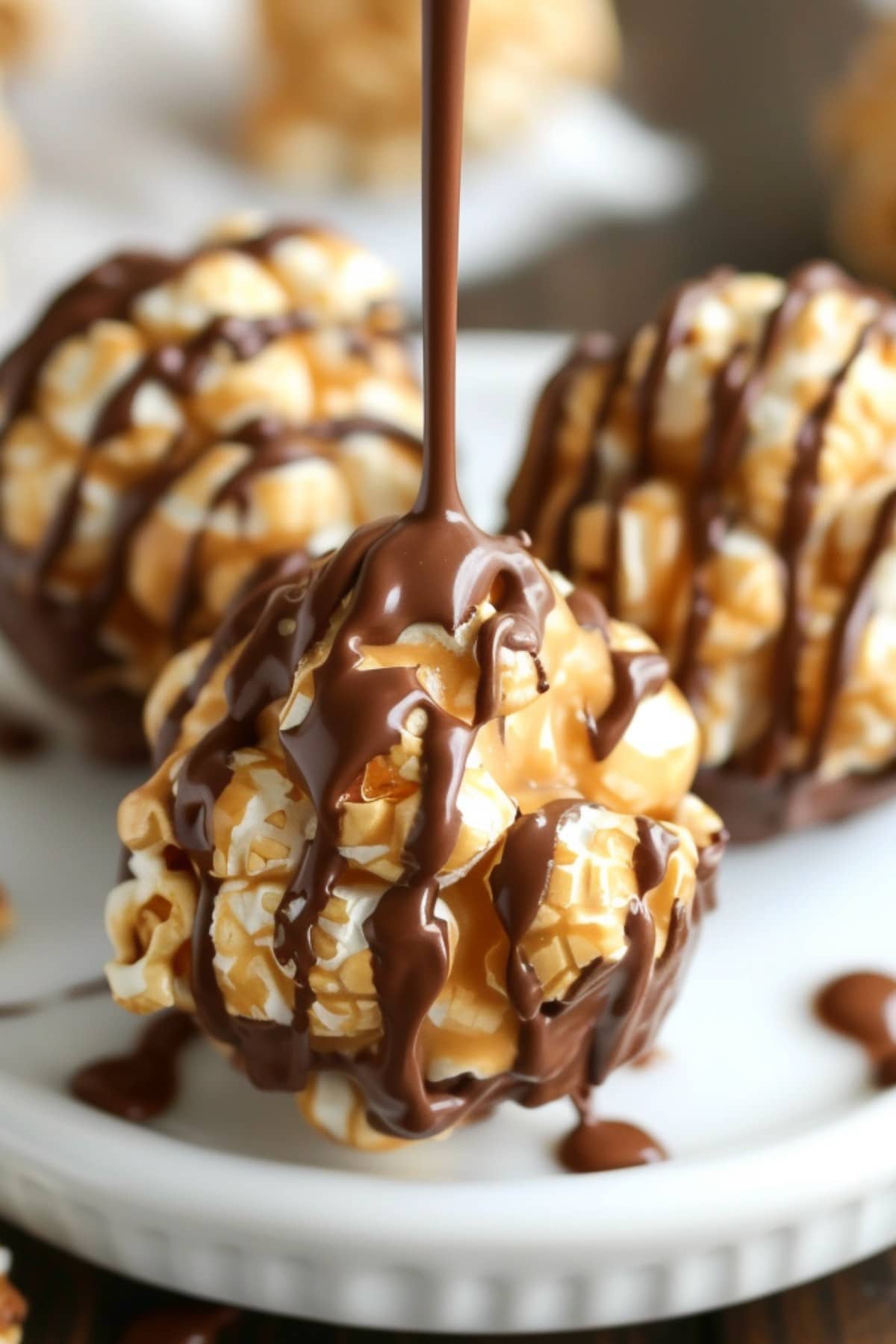 Peanut Butter Popcorn Balls drizzled with chocolate