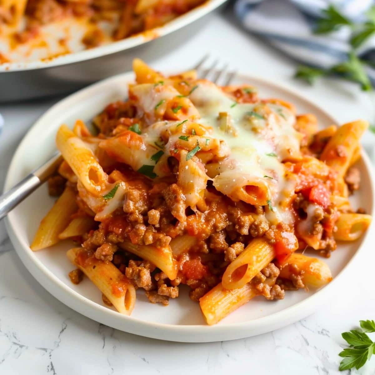 Serving of Italian sausage pasta on a plate top view.