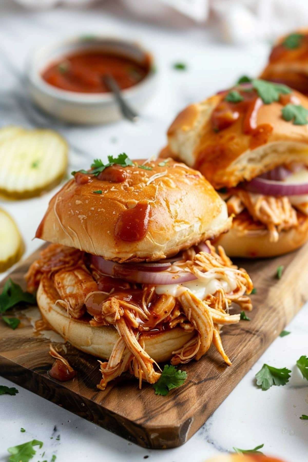 BBQ Chicken Slider rolls in a wooden board.