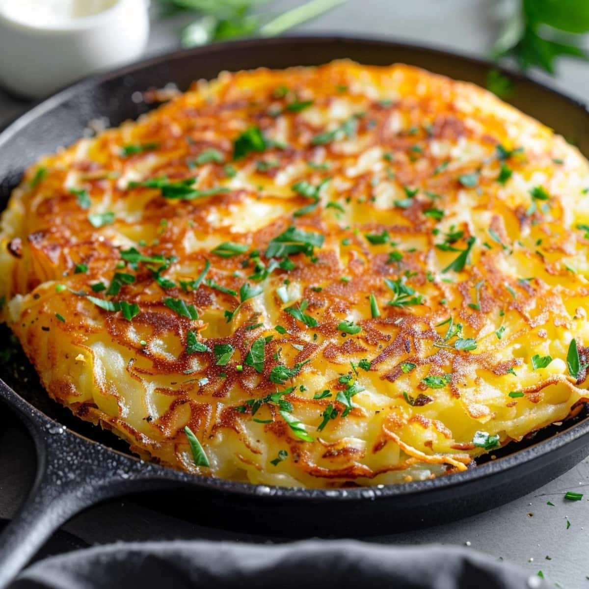 Crispy bubble and squeak cooked in a cast iron pan.