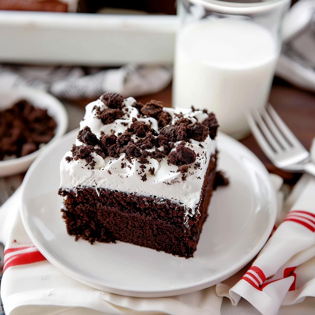 Sweet chocolate poke cake with crushed oreos and whip topping