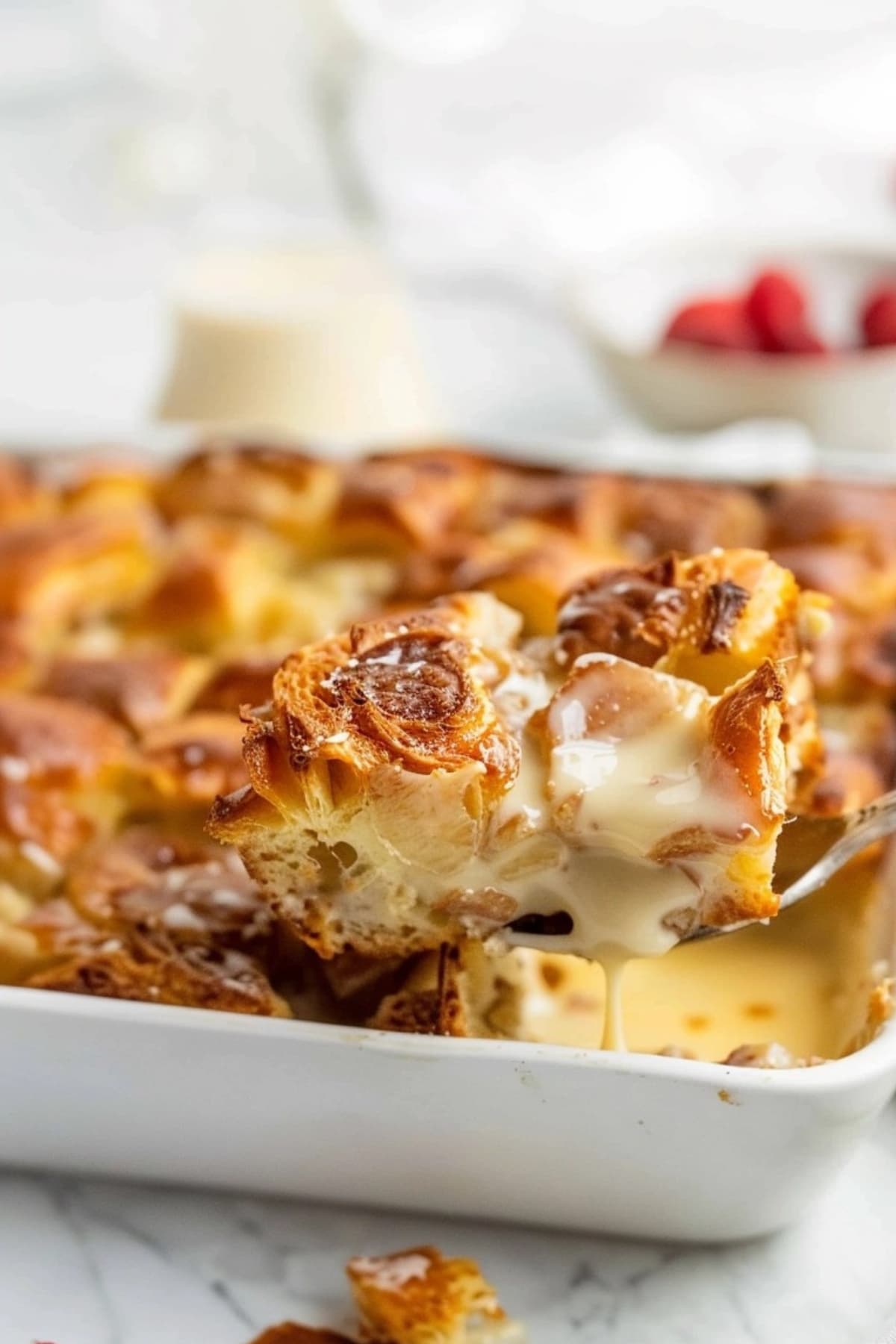 Cake ladle scooping a slice of Croissant Bread Pudding.